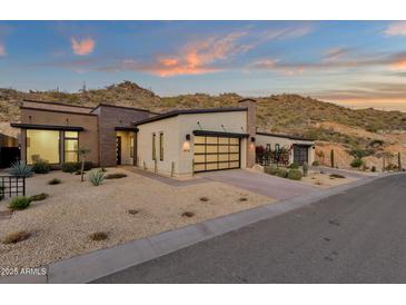 Stunning single-story home with a modern design, desert landscaping, and a backdrop of picturesque mountain views at 14715 N Adero Canyon Dr, Fountain Hills, AZ 85268