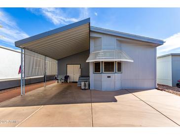 Charming single-story home with covered carport and awning over the front windows at 17200 W Bell Rd # 1628, Surprise, AZ 85374