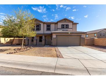 Inviting two-story home with a well-maintained yard and an attached two-car garage at 25589 W Pleasant Ln, Buckeye, AZ 85326