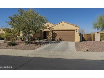 Charming single-story home with desert landscaping, a spacious driveway, and a two-car garage at 25742 N 103Rd Dr, Peoria, AZ 85383