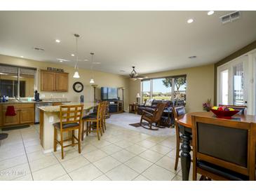 Bright living room featuring tile flooring, an island, and a beautiful living area with leather furniture and a great view at 2662 S Springwood S Blvd # 338, Mesa, AZ 85209