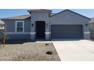 Charming single-story home with a gray exterior, covered entry, and two-car garage at 48467 N Duran Way, Gold Canyon, AZ 85118