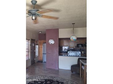 Cozy kitchen featuring tiled floors, a ceiling fan, and stainless steel appliances at 8020 E Thomas Rd # 313, Scottsdale, AZ 85251