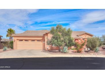 Charming home featuring a two-car garage and desert landscaping at 19973 N Monte Ln, Maricopa, AZ 85138