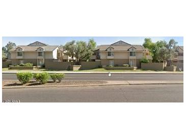 Inviting two-story townhomes with neutral exterior and lush greenery along a street at 2035 S Elm St # 114, Tempe, AZ 85282