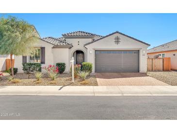 Charming single-story home features a stucco exterior, tile roof, arched entry, and a two-car garage at 25945 W Sands Dr, Buckeye, AZ 85396