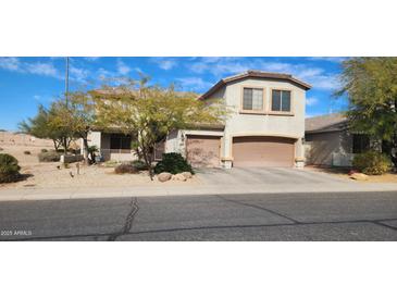 Charming two-story home featuring a two-car garage, desert landscaping, and an inviting covered porch at 5924 W Running Deer Trl, Phoenix, AZ 85083