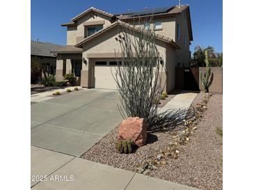 Charming two-story home featuring a desert-landscaped front yard and a two-car garage at 15266 N 146Th Ln, Surprise, AZ 85379