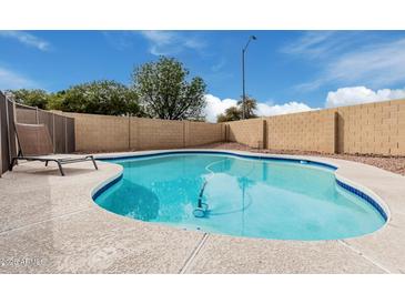 A private backyard oasis featuring a sparkling pool surrounded by desert landscape, perfect for relaxation at 15618 N 12Th Ave, Phoenix, AZ 85023