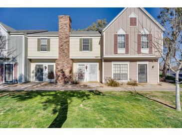 Charming townhome featuring a brick chimney and well-maintained front lawn at 1600 N Saba St # 224, Chandler, AZ 85225