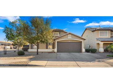 Charming single Gathering home with a two-car garage, desert landscaping, and neutral tones at 16207 W Moreland St, Goodyear, AZ 85338