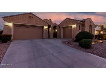 Inviting home featuring a two-car garage, desert landscaping, and an arched entryway at 2089 E Lynx Pl, Chandler, AZ 85249