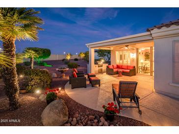 Inviting covered patio features comfortable seating and a built-in grill, perfect for outdoor entertaining at 23318 N Las Positas Ct, Sun City West, AZ 85375