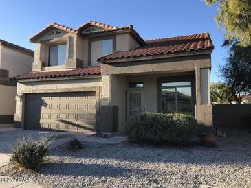 Charming two-story home with a well-maintained front yard and neutral-colored stucco exterior at 25646 W Elwood St, Buckeye, AZ 85326