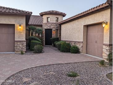 Charming home with a turret entry, well-maintained landscaping, and a brick-paved walkway, perfect for curb appeal at 3212 E Constance Way, Phoenix, AZ 85042