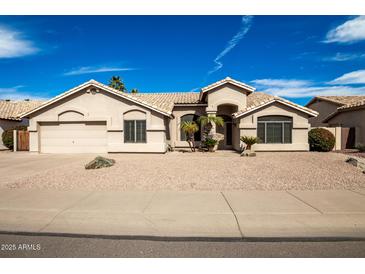 Charming single-story home featuring a two car garage, desert landscaping and a tile roof at 3602 W Barcelona Dr, Chandler, AZ 85226