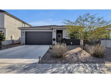 Charming single story home with a two car garage, landscaped yard, and cozy front entrance at 36243 W San Clemente Ave, Maricopa, AZ 85138