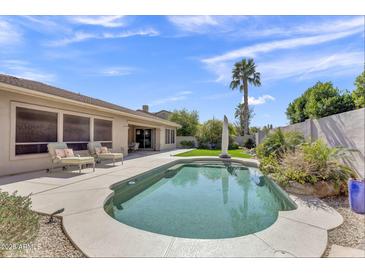 Inviting backyard pool area featuring lounge chairs and a well-maintained patio, perfect for relaxation and outdoor enjoyment at 7686 S Myrtle Ave, Tempe, AZ 85284