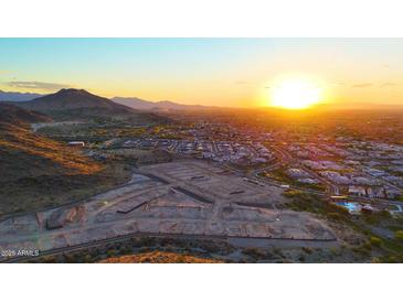 Breathtaking aerial view showcasing the community, desert landscape, and a stunning sunrise at 9831 S 11Th St, Phoenix, AZ 85042