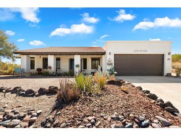 Charming single-story home with a brown tile roof and a two-car garage, surrounded by desert landscaping at 17037 E El Pueblo Blvd, Fountain Hills, AZ 85268