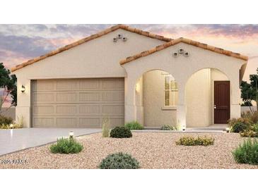 Charming single-story home with desert landscaping, a two-car garage, and an arched entryway at 1738 S 246Th Ln, Buckeye, AZ 85326