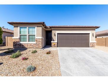 Charming single-story home with stone accents, desert landscaping, and a two-car garage at 17588 W Maricopa St, Goodyear, AZ 85338