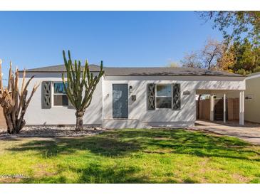 Charming single-story home with a well-maintained lawn and desert landscaping at 2219 N 13Th St, Phoenix, AZ 85006