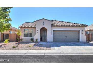 Charming single-story home with a well-maintained front yard and two-car garage, set against a clear blue sky at 2393 E San Gabriel Trl, Casa Grande, AZ 85194