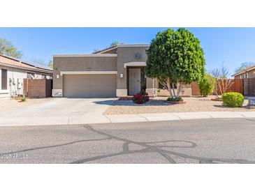 Charming single-story home with a well-manicured front yard and a two car garage at 2605 N 115Th Dr, Avondale, AZ 85392