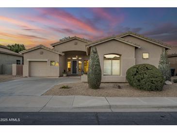 Charming single-story home with neutral stucco, manicured landscaping, and attached two-car garage at 330 W Locust Dr, Chandler, AZ 85248