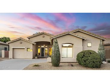 Charming single-story home with a neutral color palette, desert landscaping and inviting front entrance and attached garage at 330 W Locust Dr, Chandler, AZ 85248