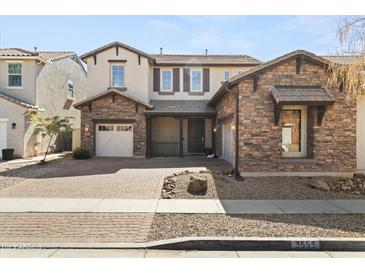 Charming two-story home featuring stone accents, well-manicured landscaping, and a welcoming front porch at 3551 E Shannon St, Gilbert, AZ 85295