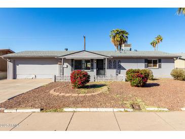 Charming single-story home with gray painted brick and well-maintained landscaping in a sunny locale at 3614 W Georgia Ave, Phoenix, AZ 85019