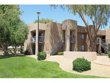 A two-story apartment building with desert landscaping and exterior staircases to the second floor units at 3810 N Maryvale Pkwy # 1089, Phoenix, AZ 85031