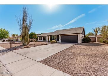 Charming single-story home with a well-manicured front yard and long driveway at 3927 W Phelps Rd, Phoenix, AZ 85053