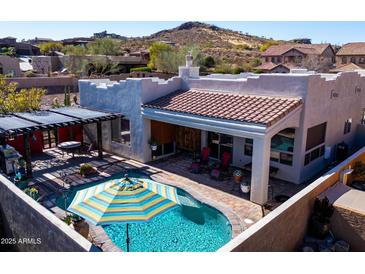 Aerial view of private backyard oasis with a pool, patio, pergola, and desert landscaping at 4309 S Priceless View Dr, Gold Canyon, AZ 85118