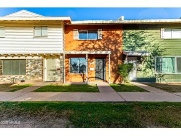 Charming townhomes with colorful exteriors and well-maintained lawns in a vibrant community setting at 4341 W Ocotillo Rd, Glendale, AZ 85301