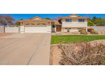 Charming home featuring a spacious driveway, two-car garage, and inviting front yard at 5226 W Tierra Buena Ln, Glendale, AZ 85306