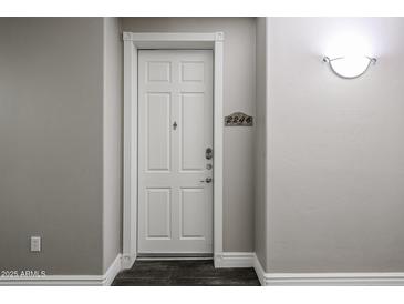 Apartment front door entrance with white door and dark floors at 5350 E Deer Valley Dr # 2246, Phoenix, AZ 85054