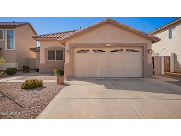 Charming single-Gathering home featuring a two-car garage and low maintenance desert landscaping at 661 E Redondo Dr, Gilbert, AZ 85296