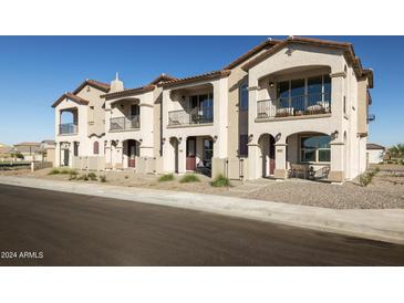 Charming townhome featuring a private balcony, desert landscaping, and inviting curb appeal at 8149 E Petunia Ave # 1041, Mesa, AZ 85212