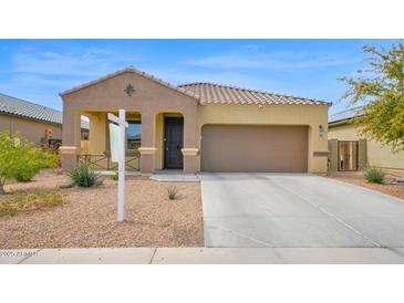 Charming single-story home featuring a well-maintained yard and attached two-car garage at 2296 S 235Th Dr, Buckeye, AZ 85326