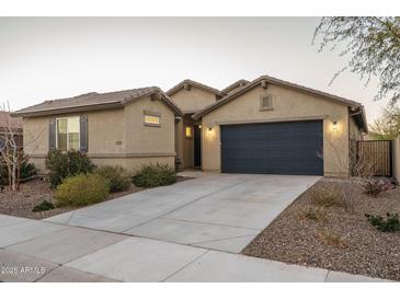 Charming single-story home featuring a two-car garage, desert landscaping, and a neutral color palette at 25330 N 134Th Dr, Peoria, AZ 85383