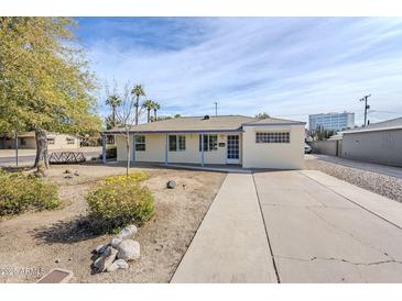 Charming single-story home featuring a well-maintained front yard and a long driveway for ample parking at 3015 N 8Th Ave, Phoenix, AZ 85013