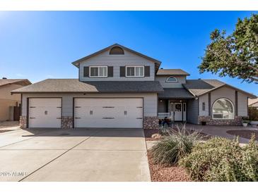 Charming two-story home with a three-car garage and well-manicured front yard at 7825 W Charter Oak Rd, Peoria, AZ 85381