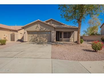 Charming single-story home featuring a two-car garage, desert landscaping, and a covered front porch at 817 S 123Rd Dr, Avondale, AZ 85323