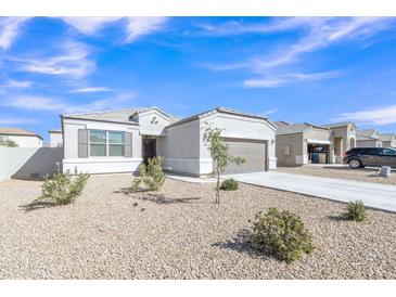 Charming single-story home with desert landscaping, a two-car garage, and a welcoming entrance at 10320 E Lupine Ln, Florence, AZ 85132