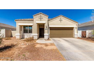 Charming single-story home with a two-car garage and desert landscaping at 18800 W Madison St, Buckeye, AZ 85326