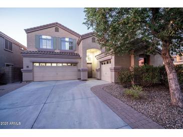 Two-story home featuring a three car garage, desert landscaping, and neutral color palette at 23914 N 25Th Way, Phoenix, AZ 85024