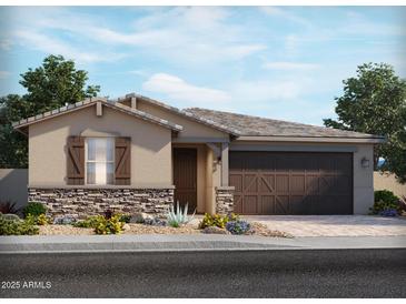 Charming single-story home featuring stone accents, desert landscaping, and a two-car garage at 24481 W Grenadine Rd, Buckeye, AZ 85326